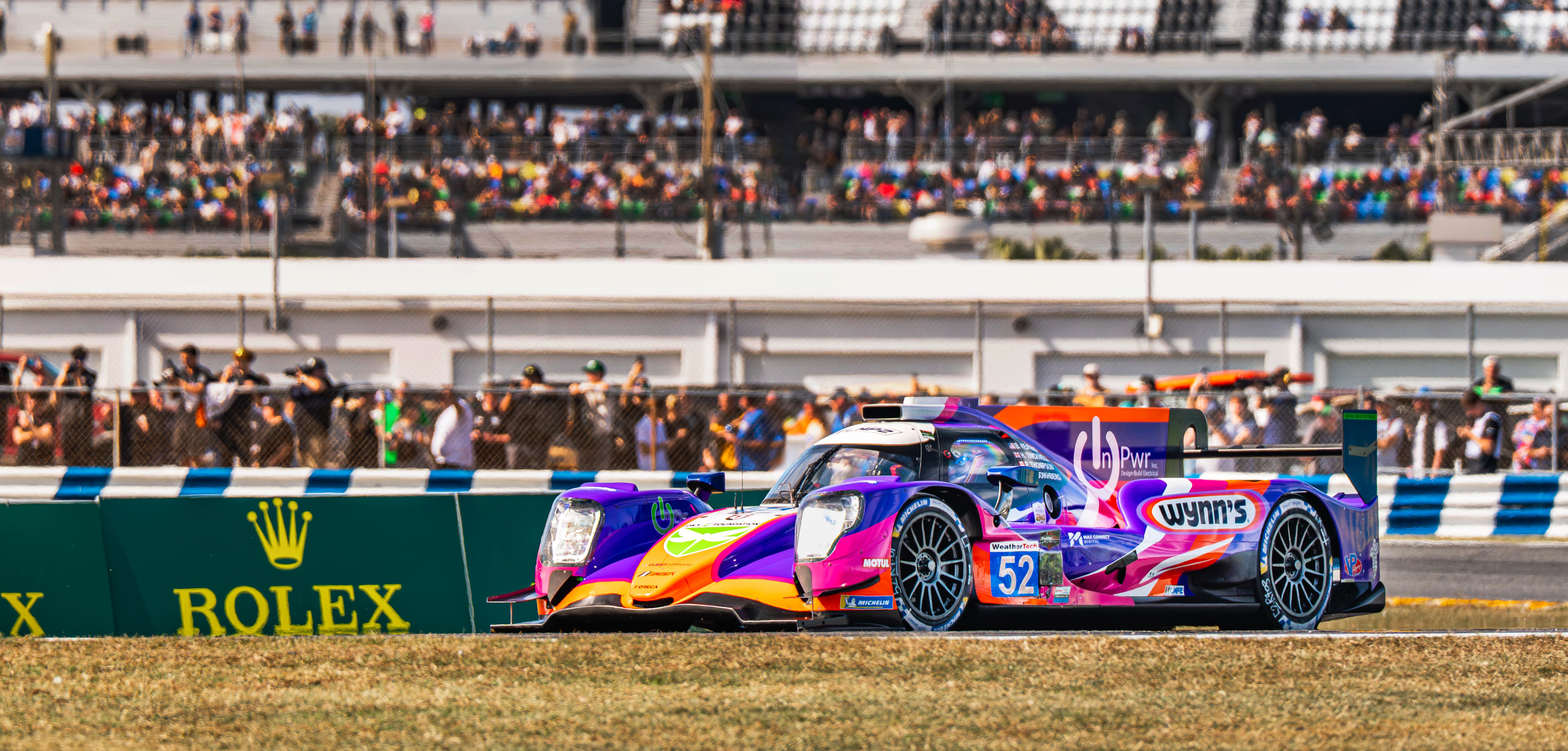 Rolex 24 at Daytona — race car at speed with motion blur, night photography